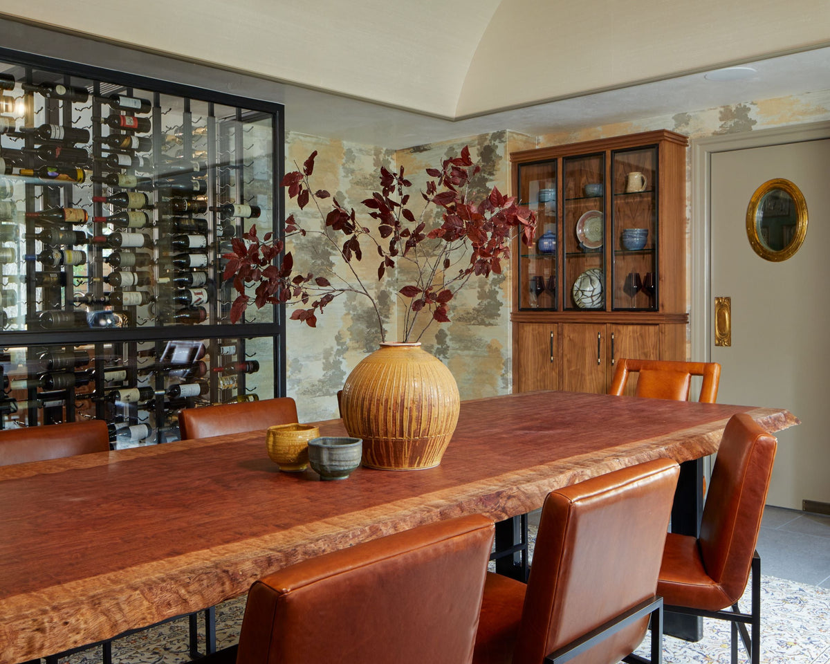 Dining room with wooden table and chairs, chandelier, and decorative wall art. Interior Design based in Amarillo, Texas. 